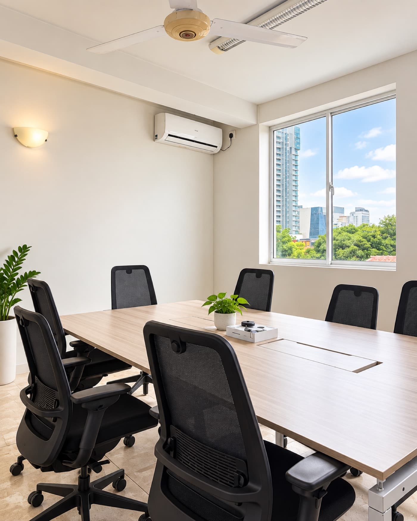 Boardroom table beside a window with a view of Colombo